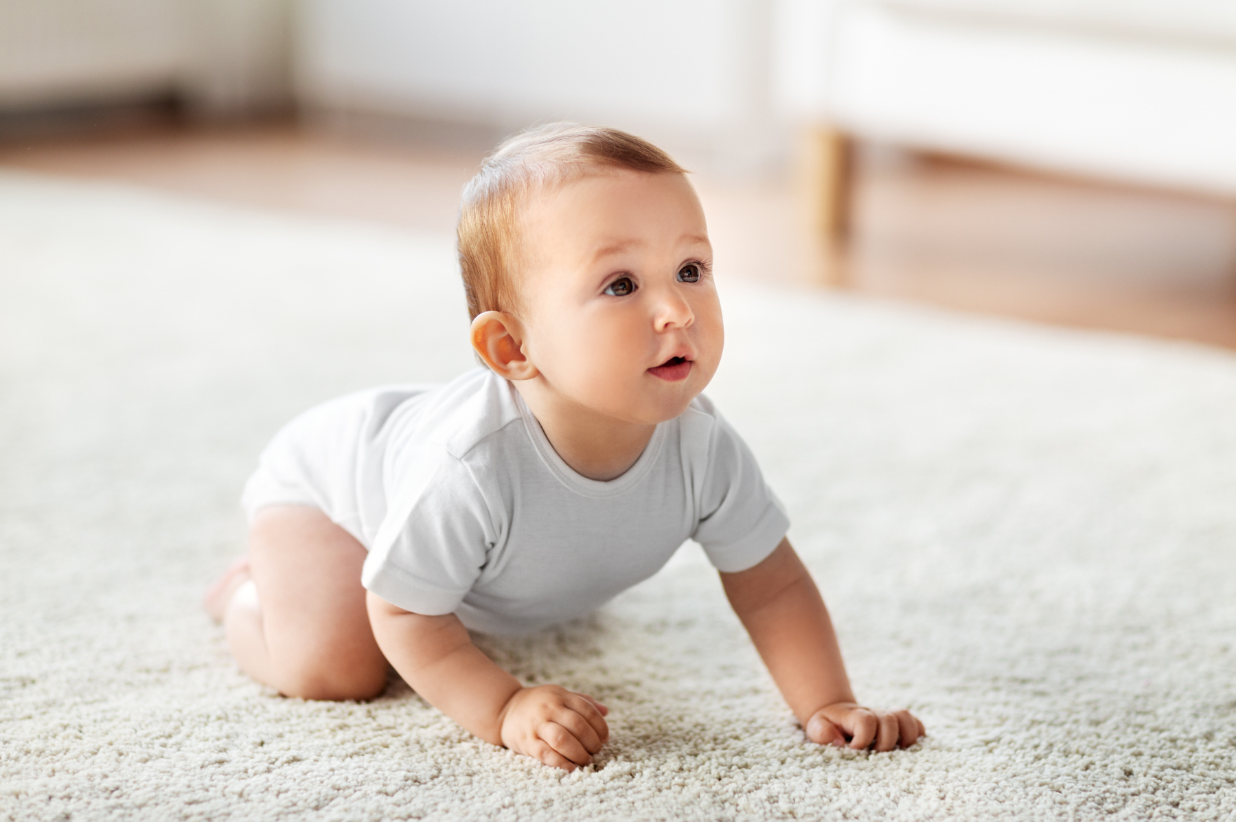 Baby crawling on a soft rug